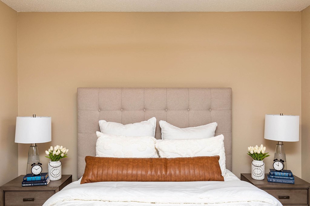 a bedroom with a bed and two nightstands with lamps at Lake Shore Park, Ankeny