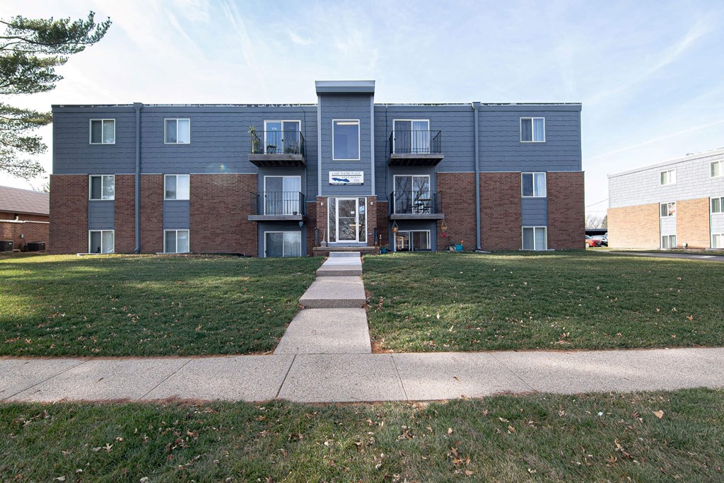 A large apartment complex with a grassy front yard. A large apartment complex with a grassy front yard at Lake Shore Place Apartments, Ankeny, IA, 50021