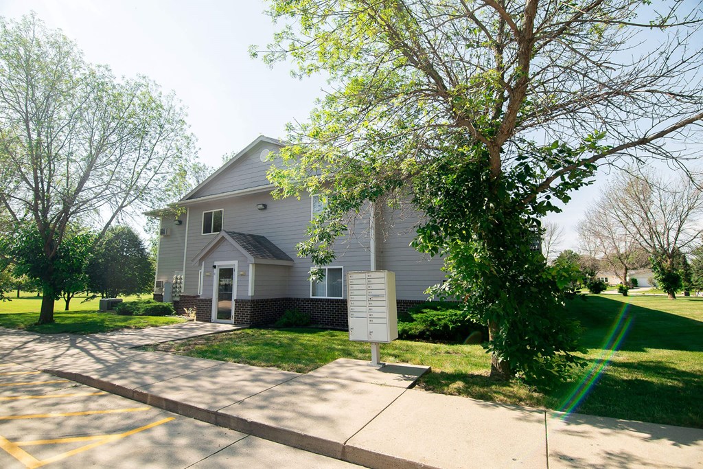 A house with a driveway and a sign in front of it at Peach Tree Apartments, Ankeny, IA,  50021