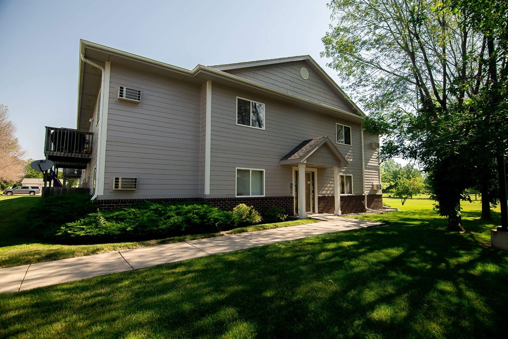 A house with a grey siding at Peach Tree Apartments, Ankeny, Iowa