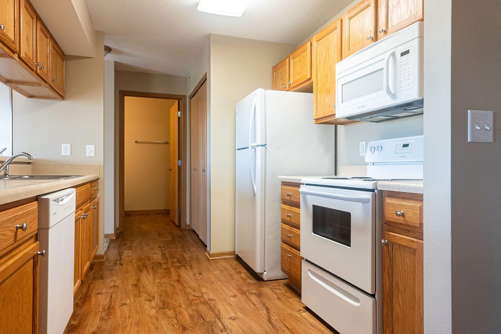 a kitchen with wood flooring and white appliances a kitchen with wood flooring and white appliances at Sunrise Meadows, Waukee