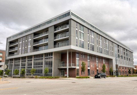 A large, modern building with a parking lot in front. A large, modern building with a parking lot in front.at City Square Lofts, Iowa, 50309