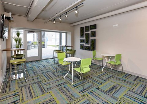 A room with a table and chairs in it.at City Square Lofts, Des Moines, IA 50309  
