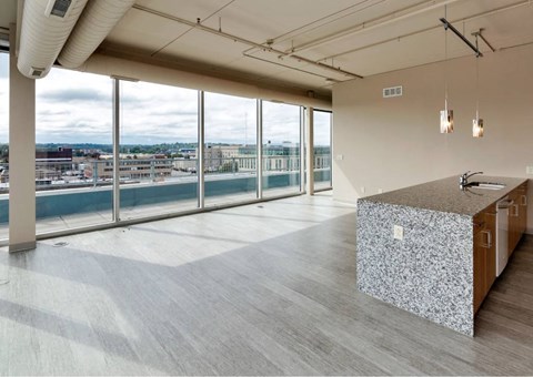 A reception area with a patterned counter and a view of the city.at City Square Lofts, Des Moines, 50309  