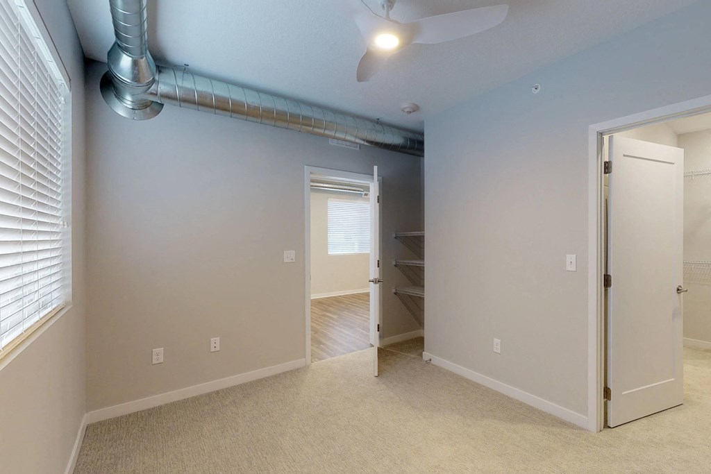 an empty room with a closet and a ceiling fan at Vue Apartments, Des Moines, Iowa