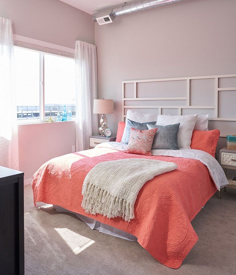 a bedroom with a bed and pillows and a window a bedroom with a bed and pillows and a window at Vue Apartments, IA, 50309