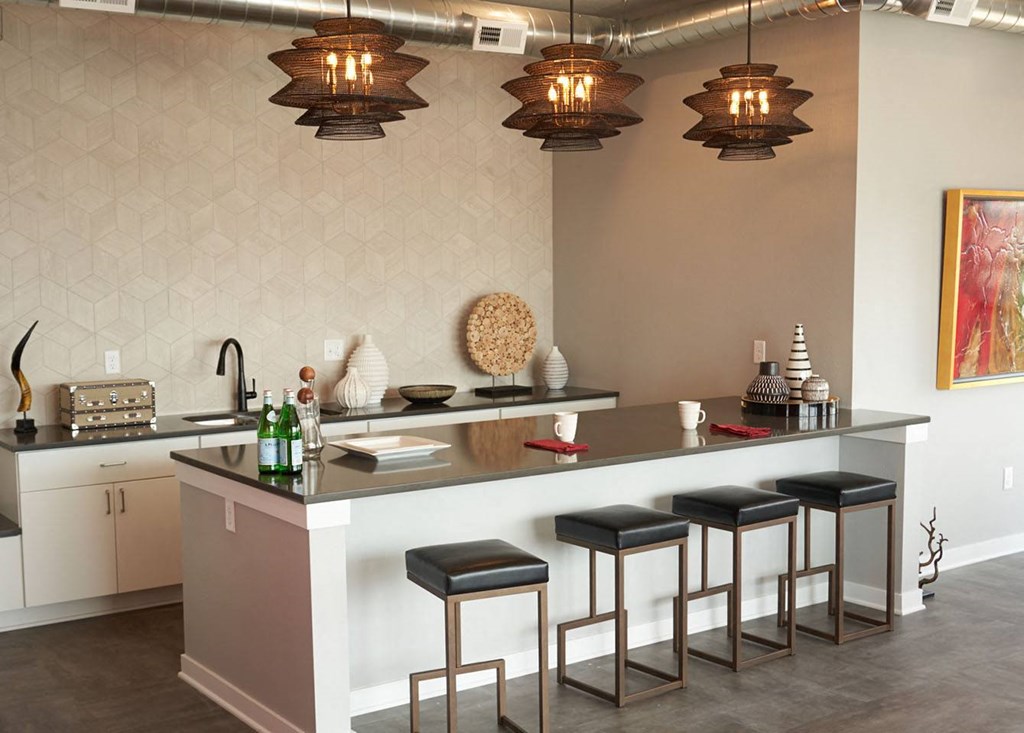 a kitchen with a counter and some stools at Vue Apartments, Des Moines, IA 50309