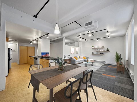 A modern kitchen with a dining table and chairs.