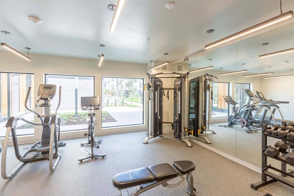 a gym with exercise equipment and a large window a gym with exercise equipment and a large window at Rowat Lofts, Des Moines, IA