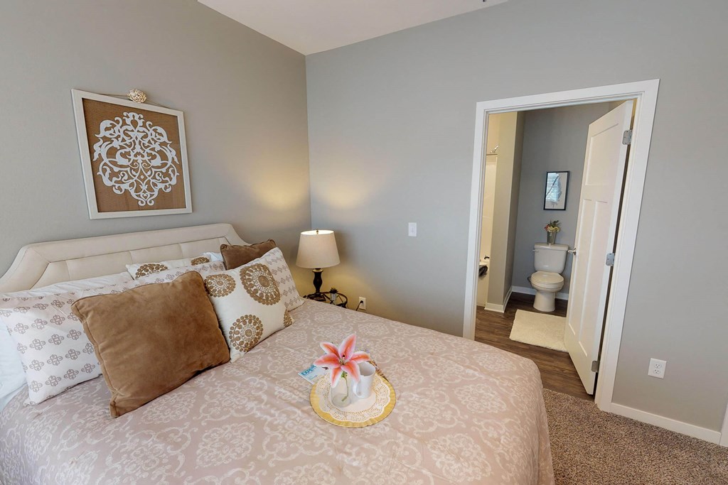 A bedroom with a large bed and a painting on the wall. at The Barclay Apartments, Altoona