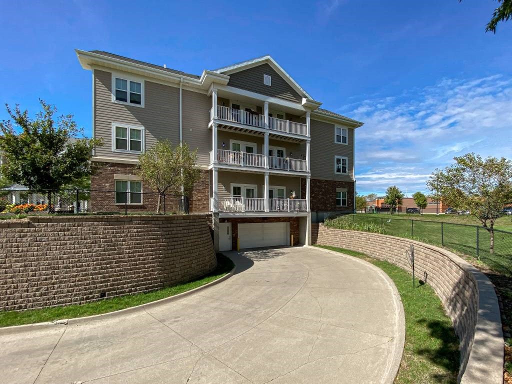 A large apartment building with a driveway in front.at Cornerstone Commons, Iowa, 50131