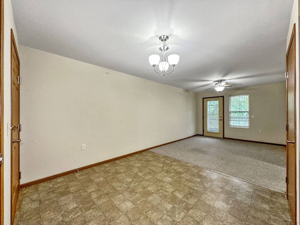 A room with a ceiling fan and a window with blinds.at Cornerstone Commons, Johnston, IA 50131  