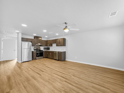 A kitchen with wooden floors and white walls.