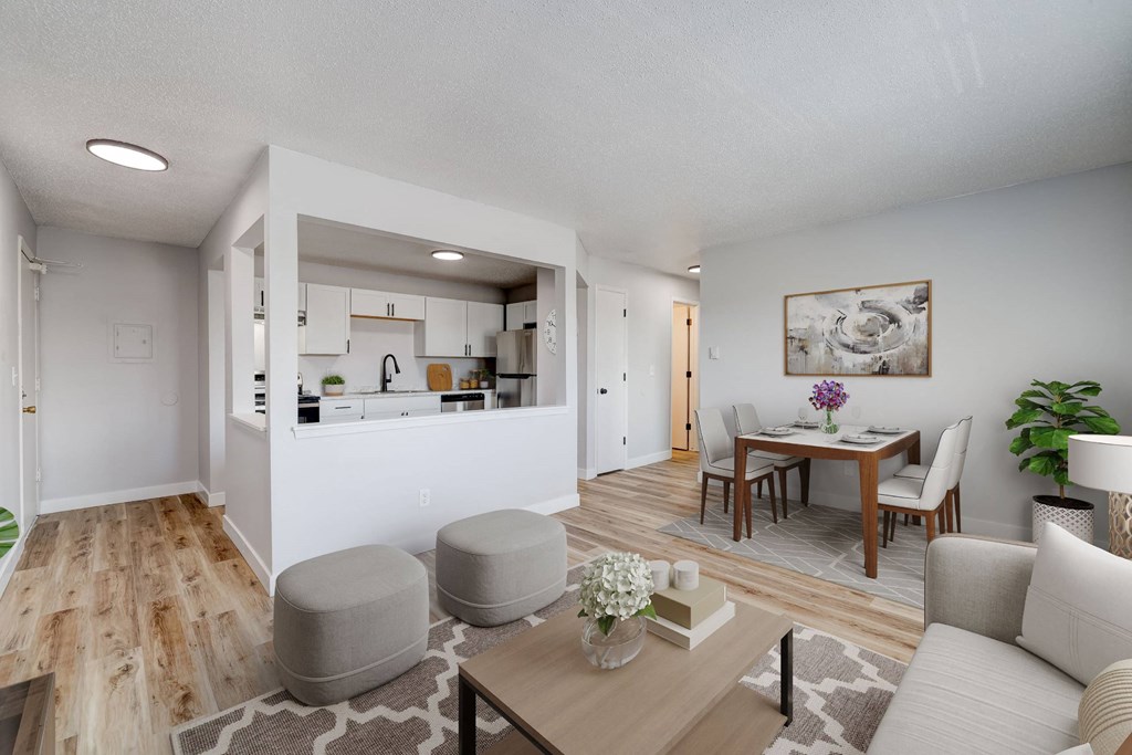 A modern living room with a kitchen in the background. A modern living room with a kitchen in the background at The Hampton Meadows Apartments, IA,50315