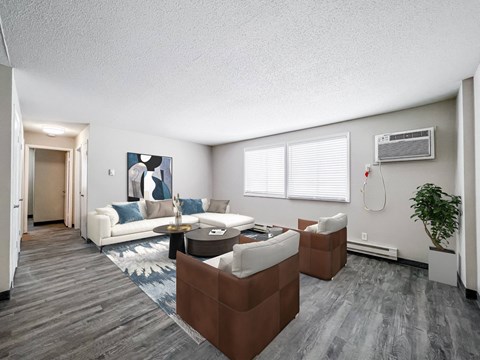 A living room with a white couch and a brown coffee table.