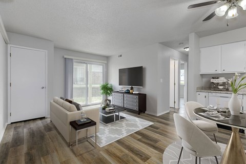 A modern living room with a white sofa and a glass coffee table.at Fish Creek, Norwalk  