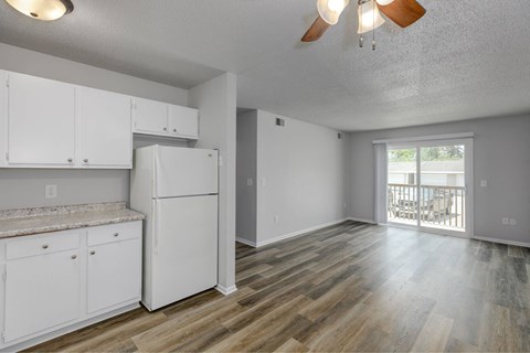 A kitchen with white cabinets and a refrigerator.at Fish Creek, Iowa, 50211