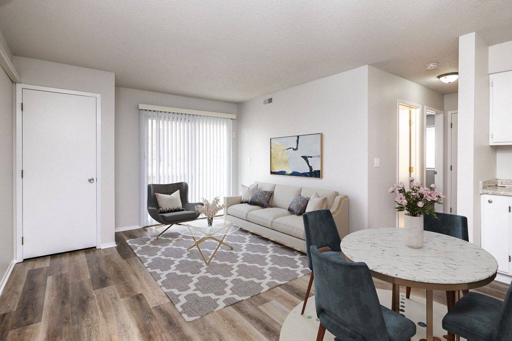 A living room with a white couch, a grey rug, and a round table with chairs. A living room with a white couch, a grey rug, and a round table with chairs.at Fish Creek, Norwalk, IA