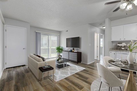 A modern living room with a white sofa and a glass coffee table.