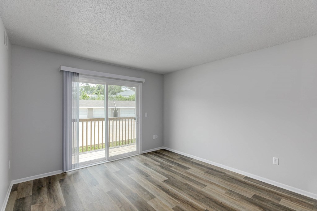 A room with a sliding glass door leading to a balcony.at Fish Creek, Iowa  