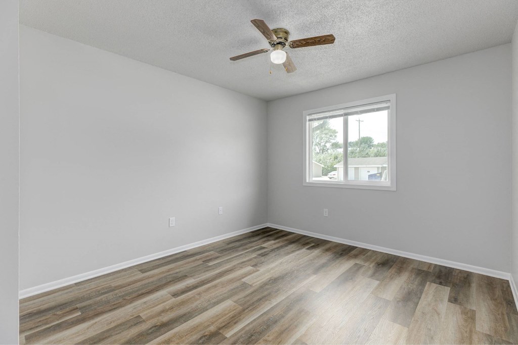 A room with a ceiling fan and a window.at Fish Creek, Norwalk, IA 50211  