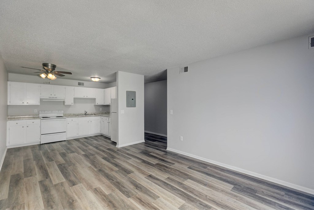 A room with a kitchen and a wood floor.at Fish Creek, Norwalk Iowa  