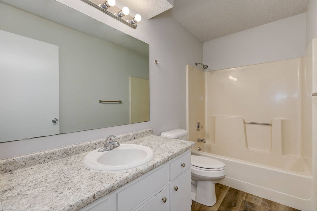 A bathroom with a sink, toilet, and bathtub.at Fish Creek, Norwalk, 50211  