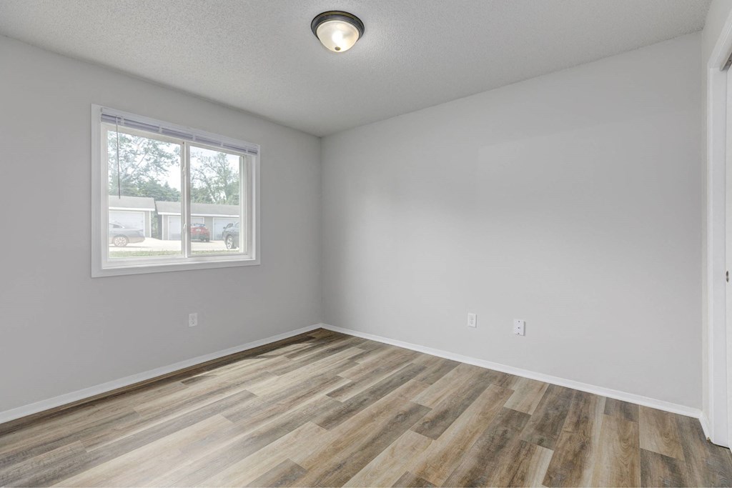 A room with a window and wooden flooring.at Fish Creek, Norwalk, 50211  