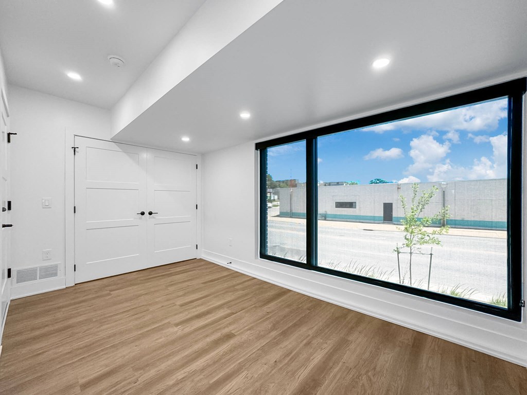 a living room with a large window and a door to the street at Matilda 235 Townhomes, Des Moines, 50309