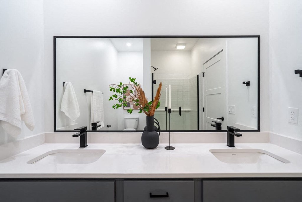 a bathroom with two sinks and a large mirror at Matilda 235 Townhomes, Des Moines, IA