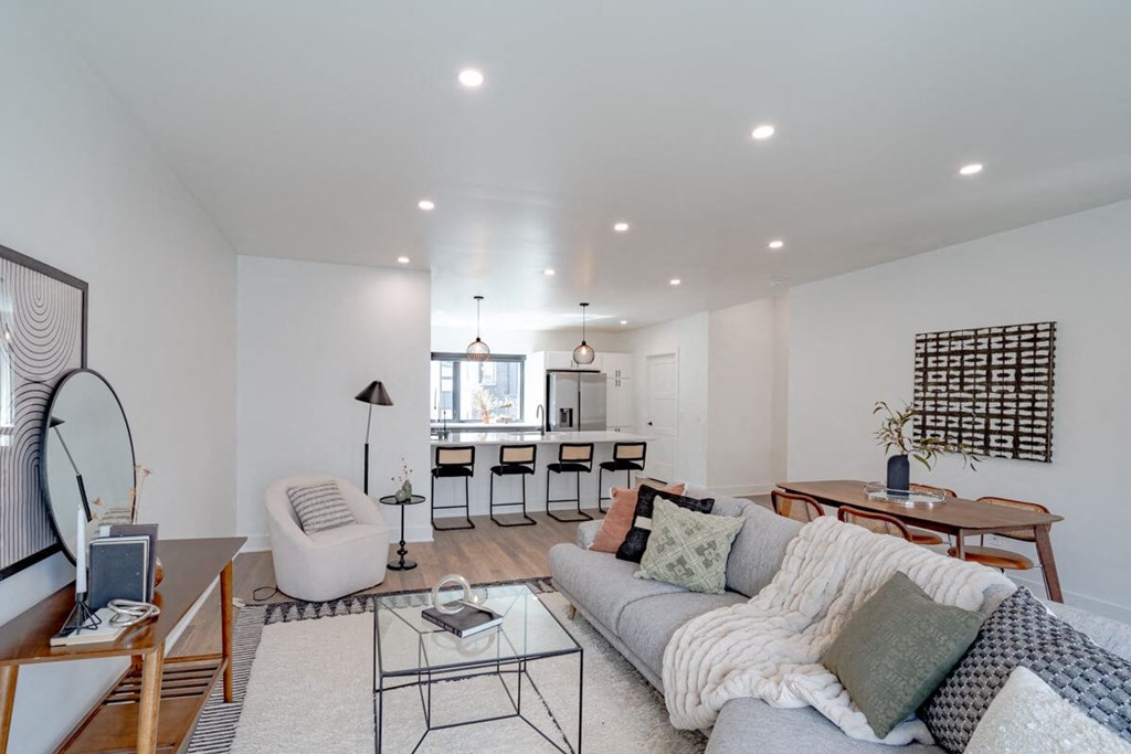 a living room with a couch and a kitchen with a table and chairs at Matilda 235 Townhomes, Des Moines