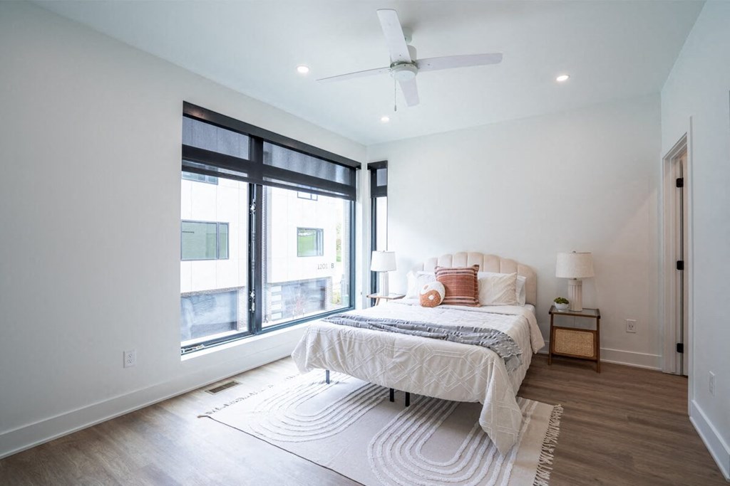 a bedroom with a bed and a large window at Matilda 235 Townhomes, Des Moines