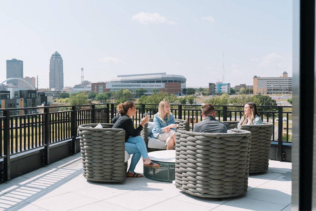 A group of people are sitting on a rooftop terrace.at Level, Des Moines  