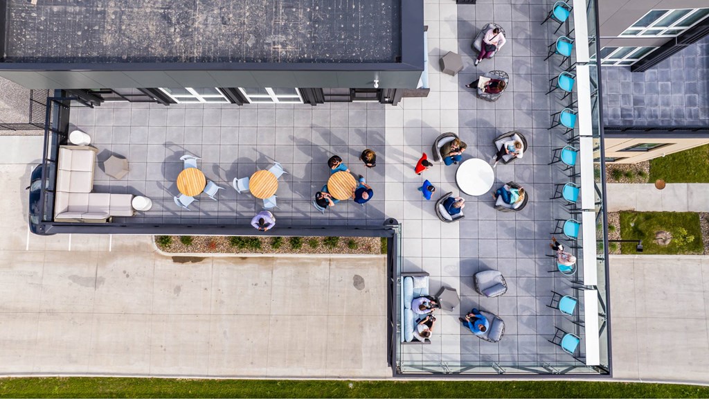 A group of people are sitting in a circle on a patio.at Level, Des Moines, IA  