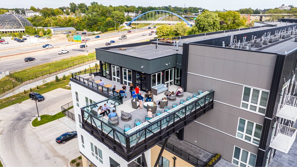 A group of people are sitting on a balcony of a building.at Level, Iowa   
