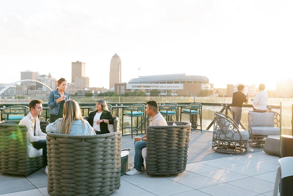 A group of people are sitting on a rooftop terrace.at Level, Iowa   