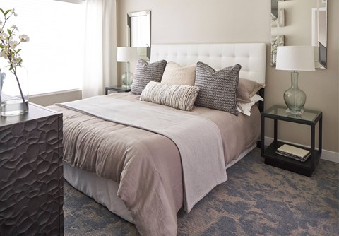 a bedroom with a bed and pillows at Linc, Des Moines  
