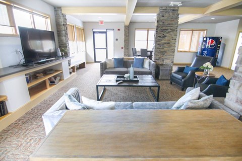 A living room with a stone pillar and a wooden coffee table.