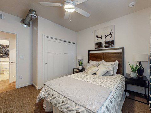 a bedroom with a bed and a ceiling fan at Melbourne Apartments, IA, 50320