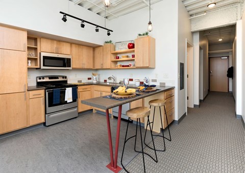 A kitchen with a table and chairs in the middle of the room.