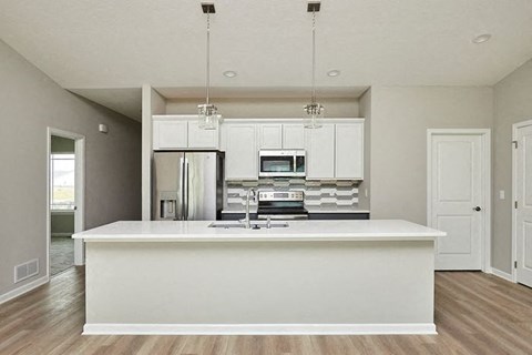 an empty kitchen with a white counter top at Two Rivers Home Rentals, West Des Moines, 50266