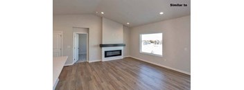 a living room with a fireplace and a wooden floor at Two Rivers Home Rentals, West Des Moines, 50266