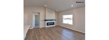 a living room with a fireplace and a wooden floor at Two Rivers Home Rentals, West Des Moines, IA