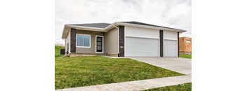 A two-car garage is attached to a house. at Two Rivers Home Rentals, West Des Moines, IA