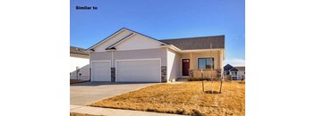 a white house with a porch and a driveway at Two Rivers Home Rentals, Iowa