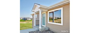a house with a blue door and a large window at Two Rivers Home Rentals, West Des Moines, 50266