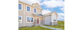 a tan house with a red door and a green yard at Two Rivers Home Rentals, West Des Moines, IA