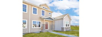 a tan house with a red door and a green yard at Two Rivers Home Rentals, West Des Moines, 50266