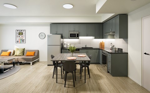 A modern kitchen with a dining table set for two.
