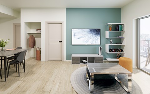 A modern living room with a grey table and a television on the wall.